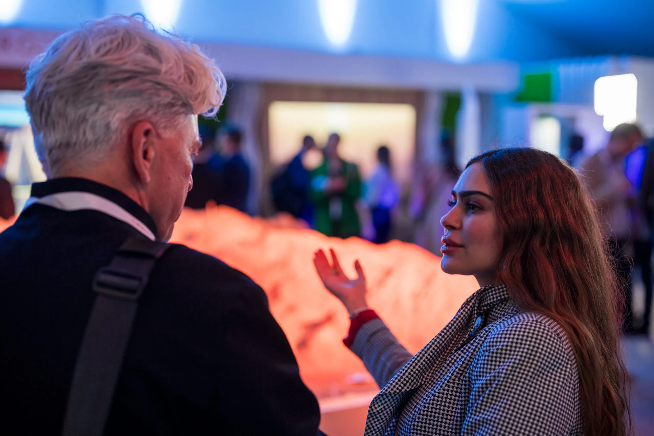 Two guests in conversation beside the terrain model