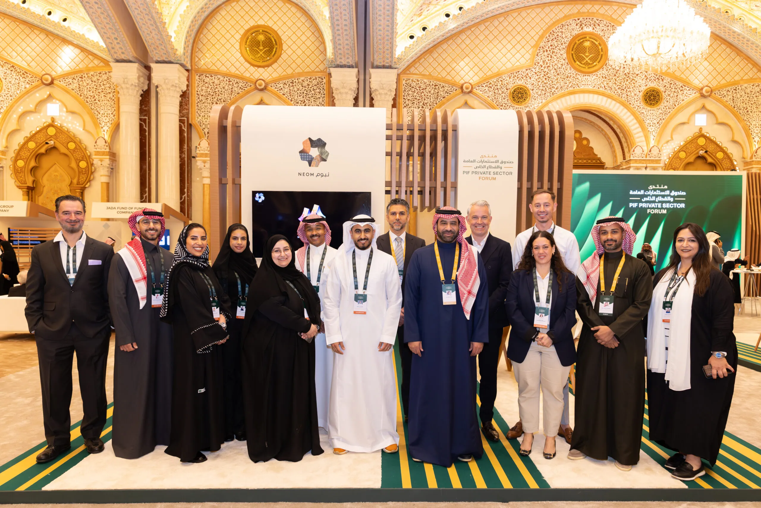 The NEOM team lined up for a group photograph at the booth