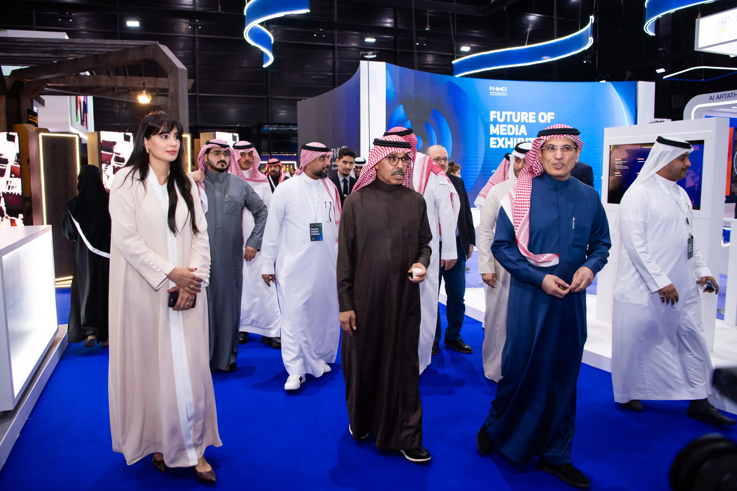 A delegation walking through the Future of Media Exhibition hall
