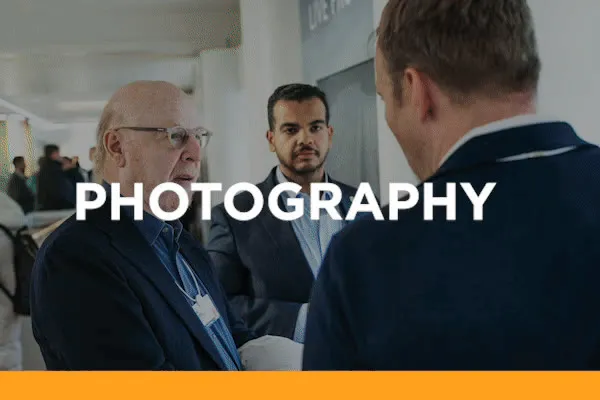 Photography — view the NEOM stills gallery. Delegates talking at a conference.