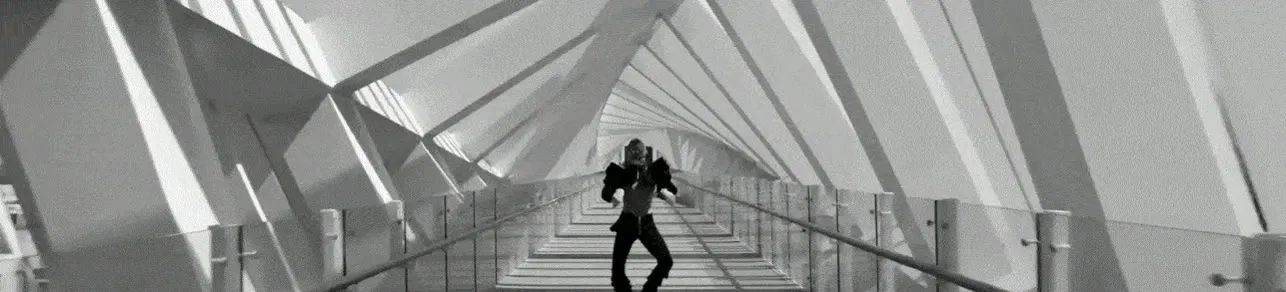 A dancer performing on a covered footbridge